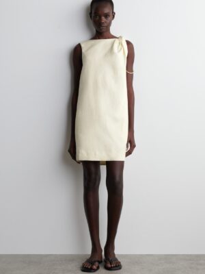 Butter yellow perfection - the shoulder twist elevates a basic shift dress.