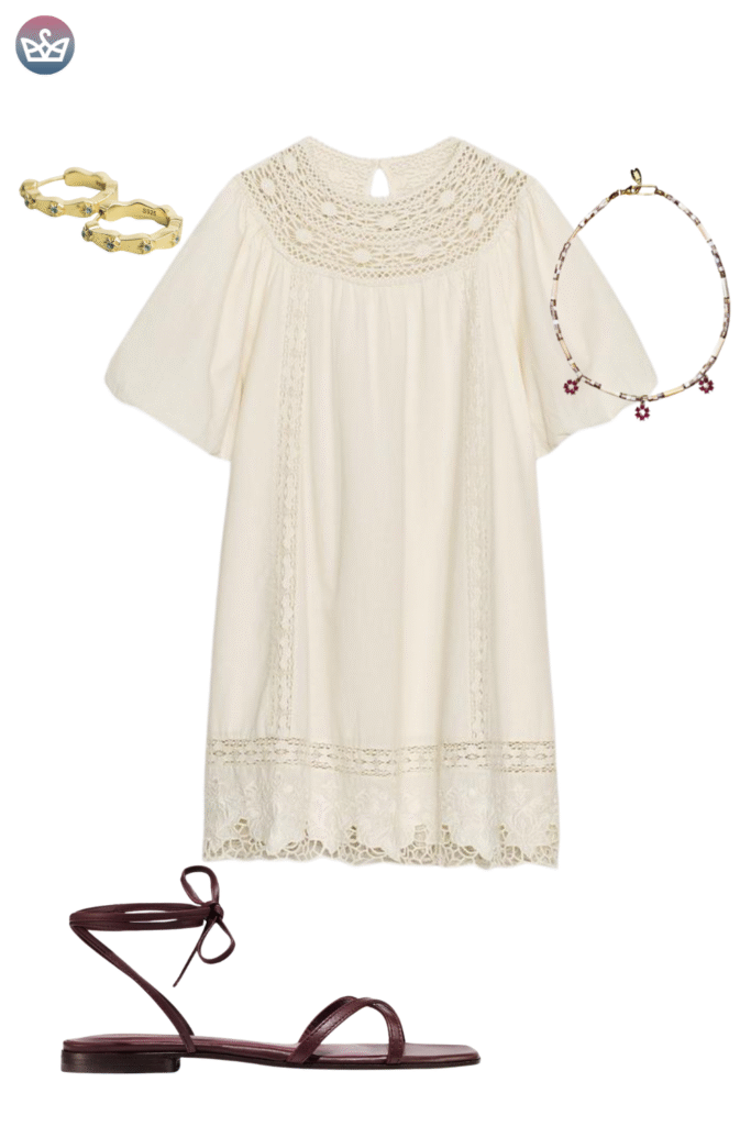 Bohemian inspired fall outfit idea featuring a cream colored lace and crochet tunic dress with flutter sleeves styled with a beaded necklace and gold bracelets The ensemble is paired with chic dark leather ankle tie sandals offering a flat open footwear option for a mild sunny autumn day