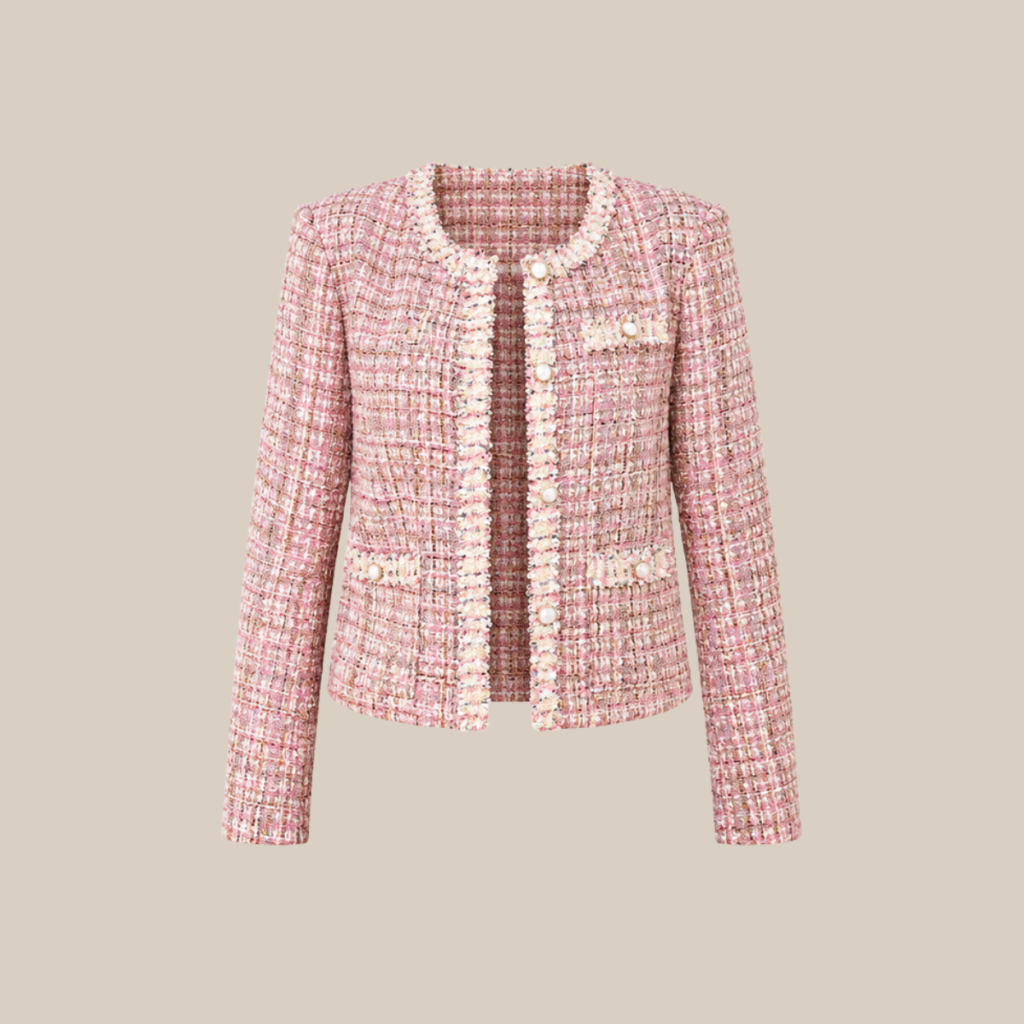Pink boucle tweed jacket with pearl buttons and fringe trim on a neutral background tldr winter work outfits are easier with seven closet staples kick crop pants office shoes in the same color a button down a merino sweater a third piece weatherproof boots and a work tote Pair the pants and shoes in one color then build the top half around a button down and a merino sweater with a  adjust my crown