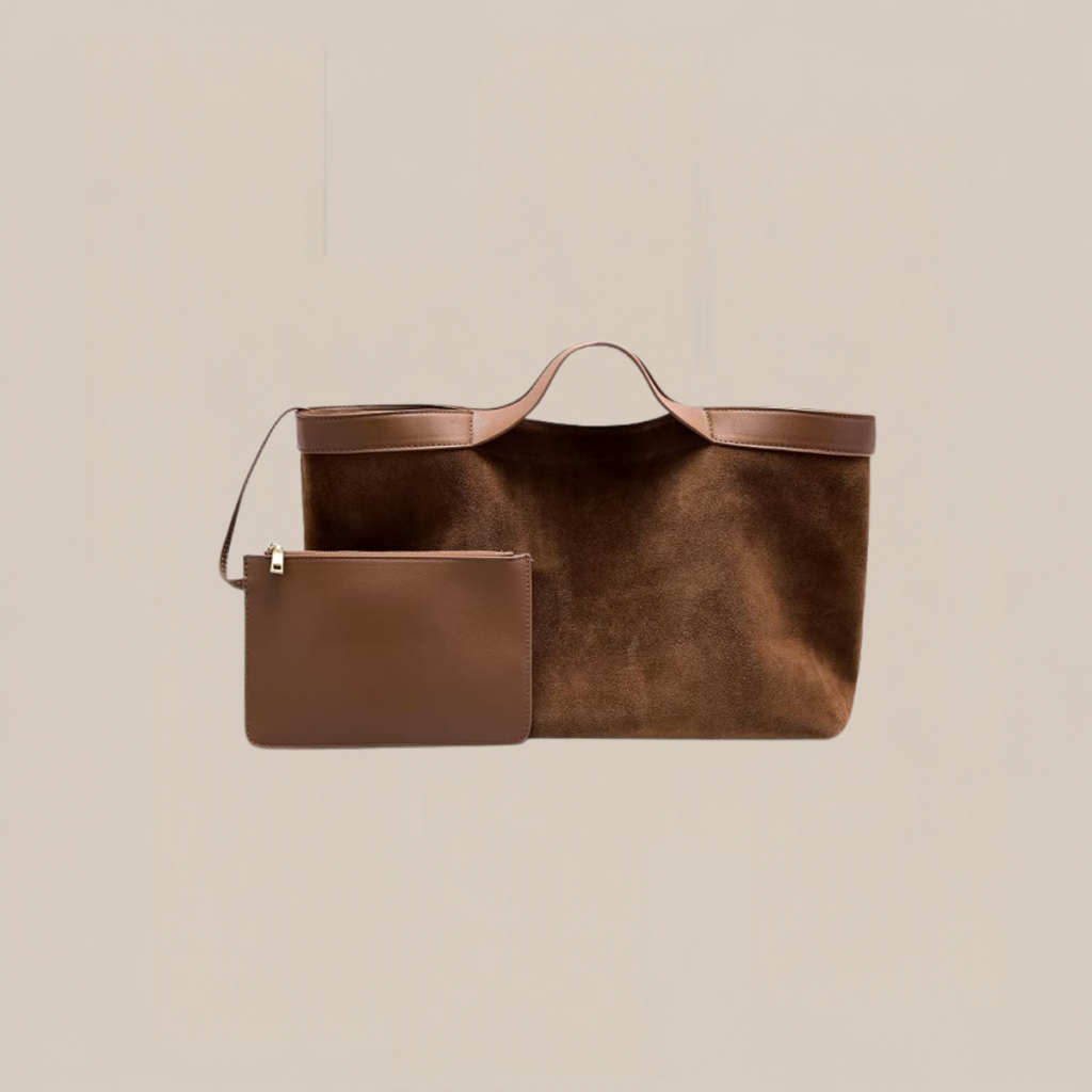 Brown suede tote bag with pink tan handles and a matching small zip pouch in front Tldr winter work outfits are easier with seven closet staples kick crop pants office shoes in the same color a button down a merino sweater a third piece weatherproof boots and a work tote Pair the pants and shoes in one color then build the top half around a button down and a merino sweater with a  adjust my crown